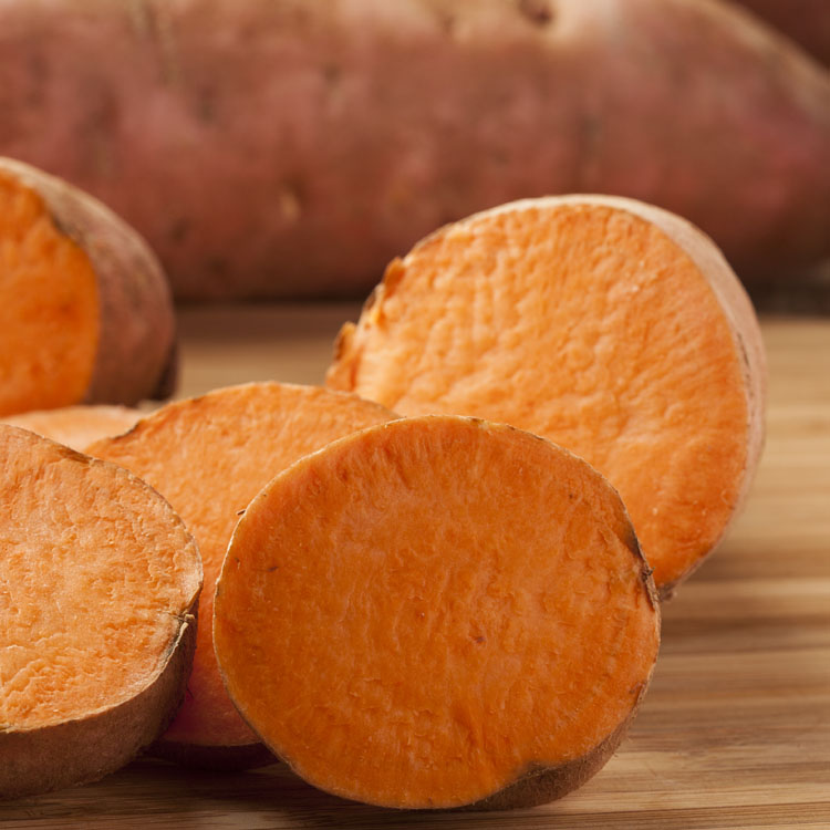 Fresh Organic Orange Sweet Potato against a background